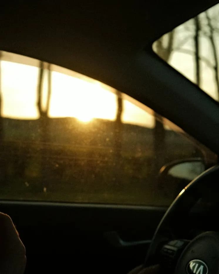 Driving into a sunset between appointments